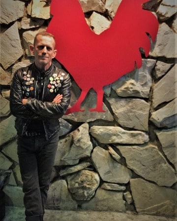 Picture of Ezra Buzzington in black jacket and black paint.